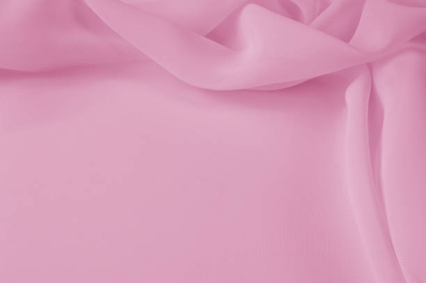 istock Texture, background, pattern. Silk fabric pale pink, abstract folds 1002764964