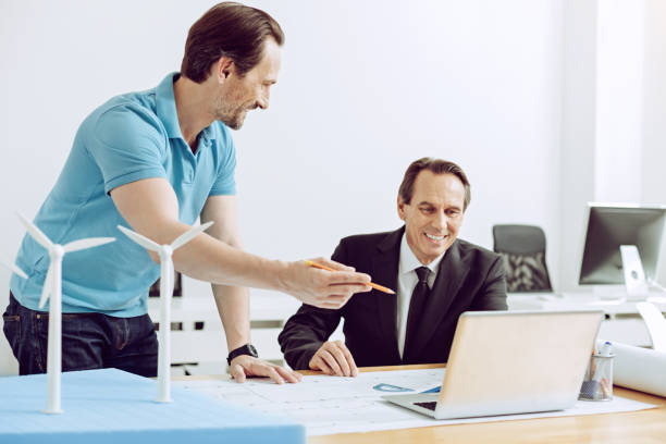 istock Satisfied man looking at the screen of a laptop 1002765620