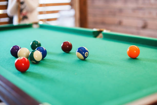 istock balls on a billiard table in a triangle. men playing billiards 1002768248