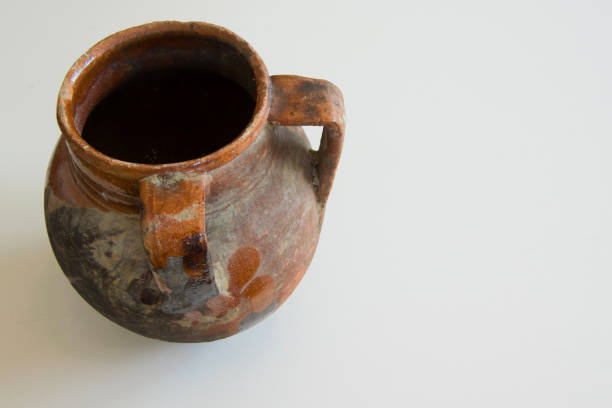 istock Antique handmade ceramic vase with two handles on white background, used to bring water or wine 1002768962