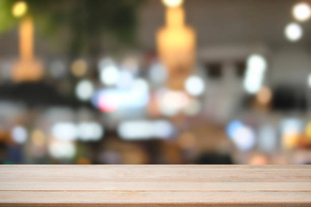 istock Wooden desk with bokeh city blur background, Table is empty. 1002774354
