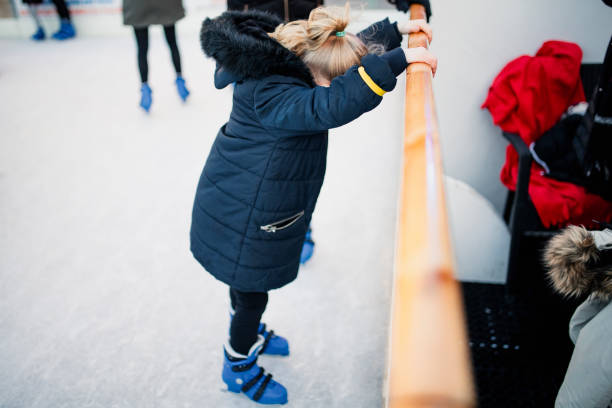 Child ice skating on an outdoor rink.