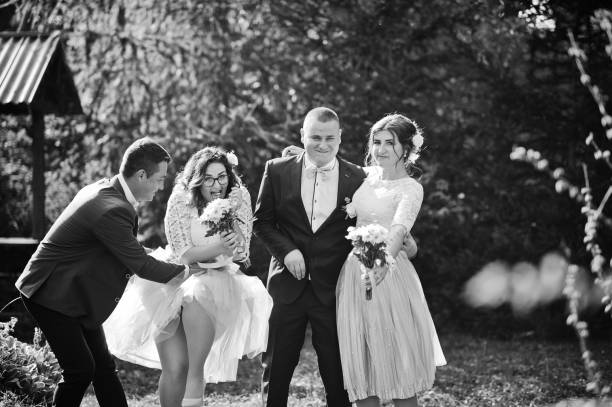 istock Groomsmen and bridesmaids having fun 1002779220