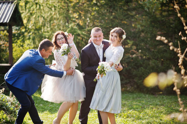 istock Groomsmen and bridesmaids having fun 1002779242
