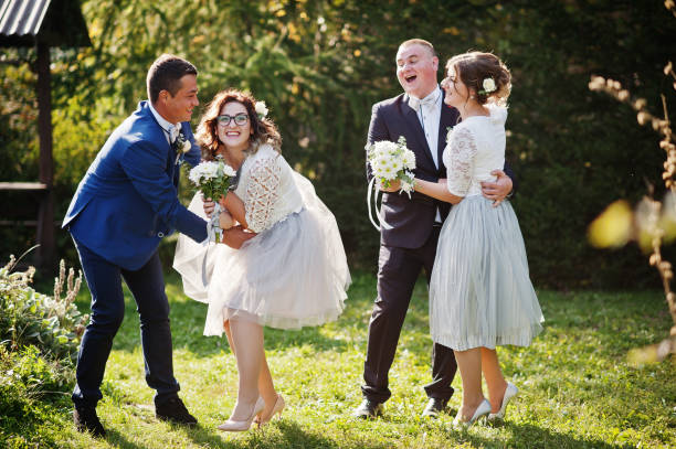 istock Groomsmen and bridesmaids having fun 1002779252