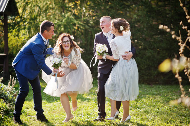 istock Groomsmen and bridesmaids having fun 1002779370