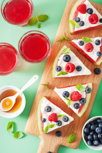 istock watermelon pizza slices with yogurt and berries, summer dessert 1002779784