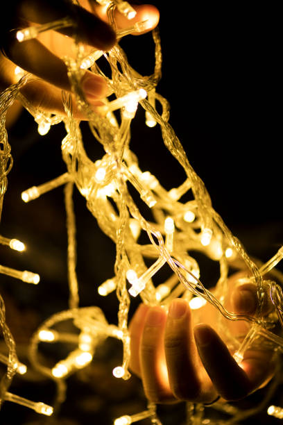 istock Hands holding garland decoration lights 1002783942