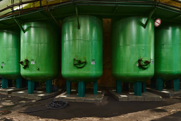 istock Stainless steel wine vats in a row inside the winery 1002794082