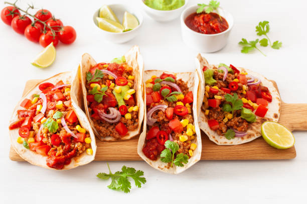 istock mexican beef and pork tacos with salsa, guacamole and vegetables 1002800640