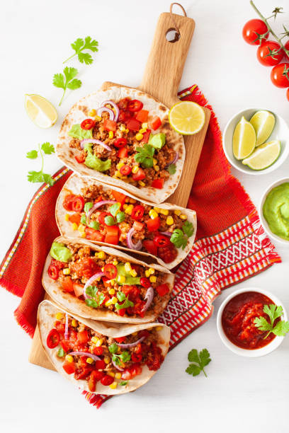istock mexican beef and pork tacos with salsa, guacamole and vegetables 1002802212