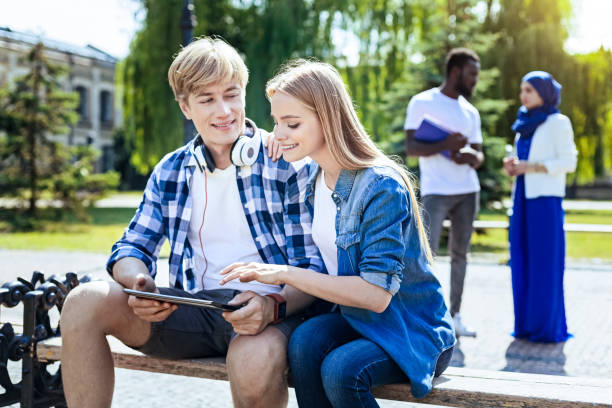 istock Relaxed college mates chatting outdoors and smiling 1002802218