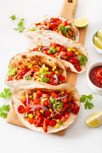 istock mexican beef and pork tacos with salsa, guacamole and vegetables 1002808878