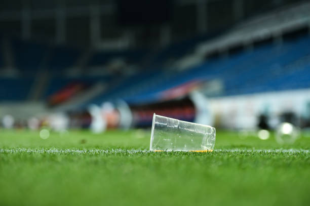 istock Plastic trash can on the turf on a soccer field 1002841152