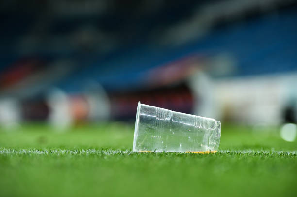 istock Plastic trash can on the turf on a soccer field 1002841156