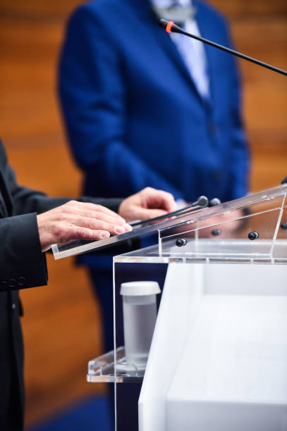 istock Detail shot with man in suits during a press conference 1002841194
