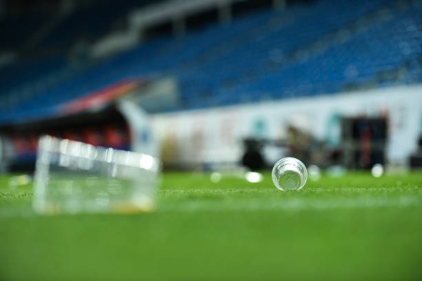 istock Plastic trash can on the turf on a soccer field 1002842588
