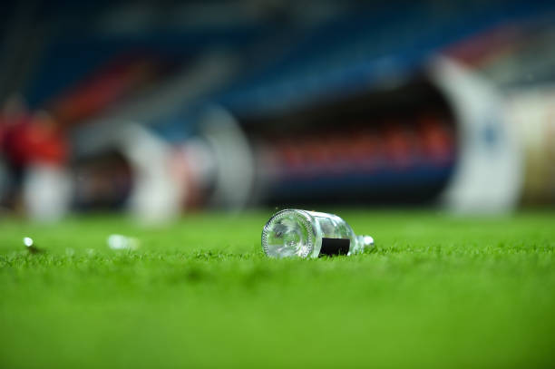 istock Plastic trash can on the turf on a soccer field 1002842590