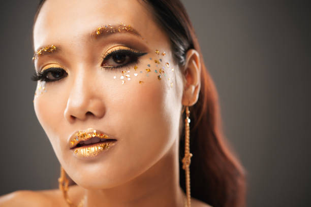 istock Gorgeous Asian female with bright glitter makeup 1002852162