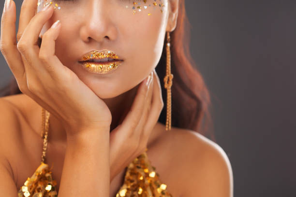 istock Beautiful woman with golden glitter makeup 1002852184