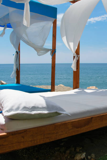 istock Luxury and romantic bed on the seashore for relaxing holidays/vacations 1002852606