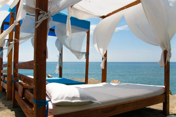 istock Luxury and romantic bed on the seashore for relaxing holidays/vacations 1002852612