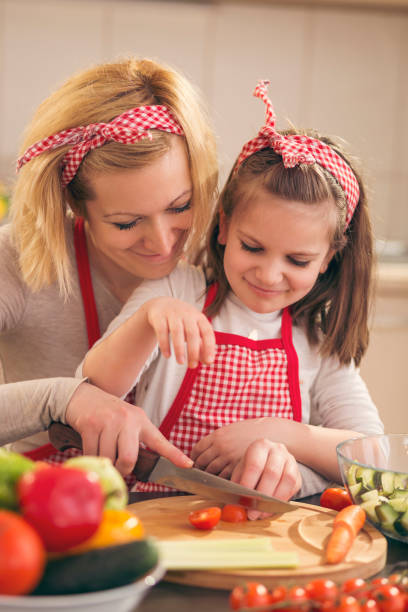 istock Mother and daughter making salad 1002855040