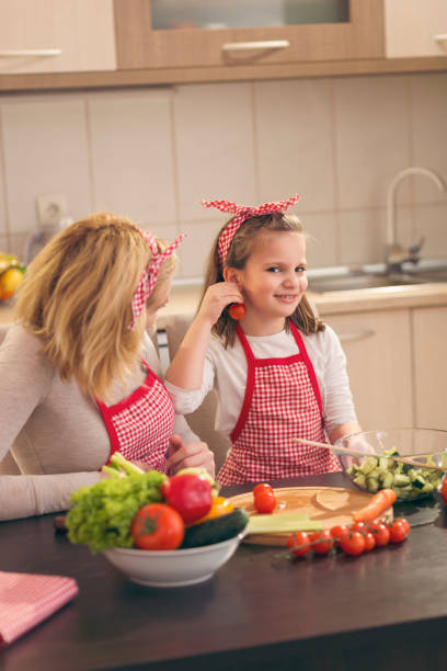 istock Mother and daughter having fun in the kitchen 1002855516