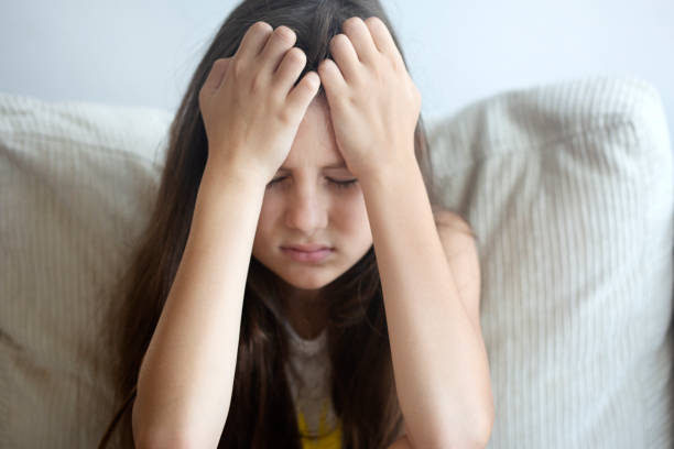 Feeling Sick Little girl having a bad headache. one girl only stock pictures, royalty-free photos & images
