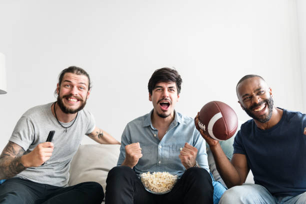 istock Friends cheering sport league together 1002855588