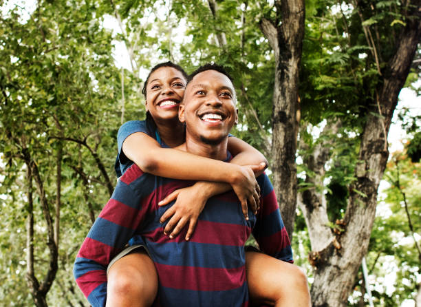 istock Man giving his girlfriend a piggyback ride 1002859022