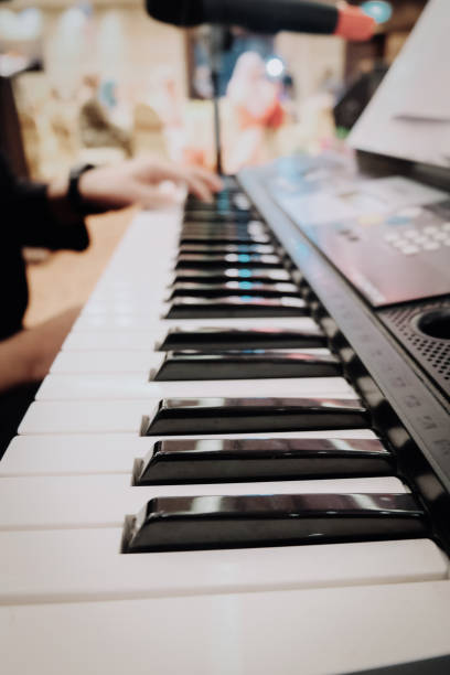 istock man hand play synthesiser electronic keyboard 1002859618
