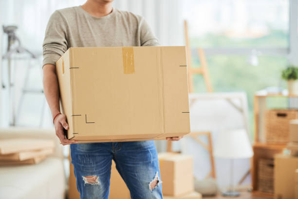 Man carrying carton box on moving day stock photo