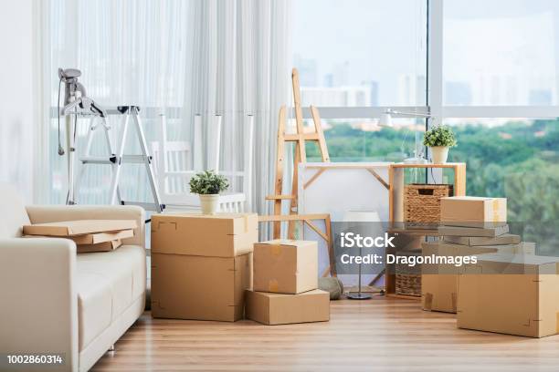 Cardboard Boxes For Moving And Drawing Easels Stock Photo - Download Image Now - Relocation, Box - Container, Moving House