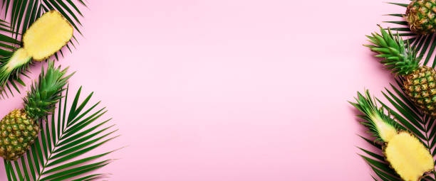istock Pattern with bright pineapples, palm leaves on pink background. Top View. Copy Space. Minimal style. Pop art design, creative summer concept. Banner 1002863350