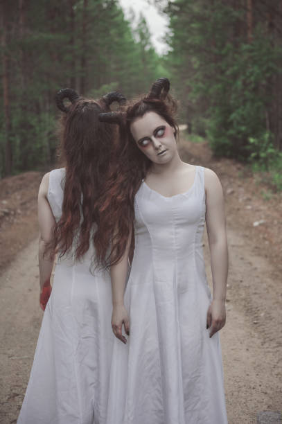 istock Two twins demons with horns in white shirt 1002863878