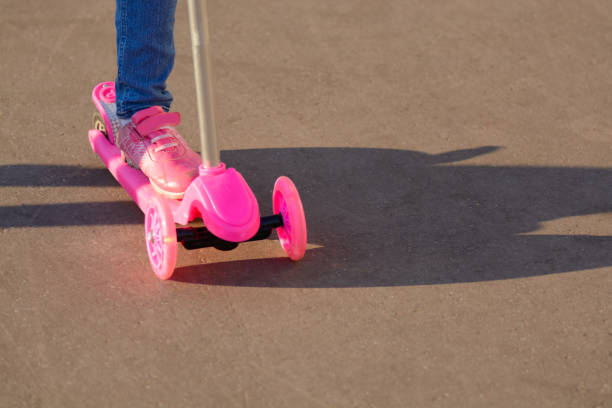istock Little girl riding a scooter 1002869026