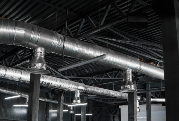 istock Ventilation system on the ceiling of large buildings. Ventilation pipes in silver insulation material hanging from the ceiling inside new building. 1002871852