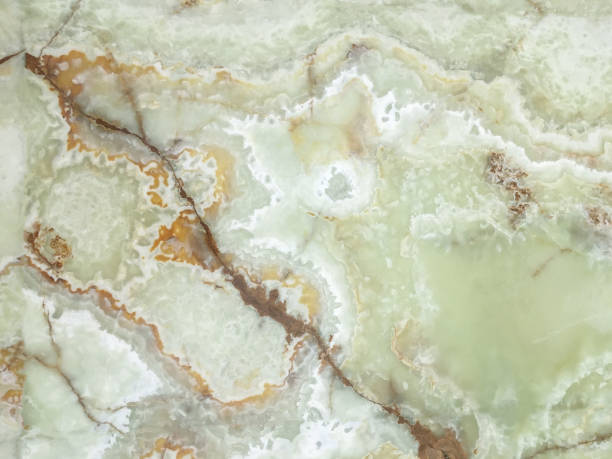 istock Green marble in a cut close-up with white impregnations. 1002872068