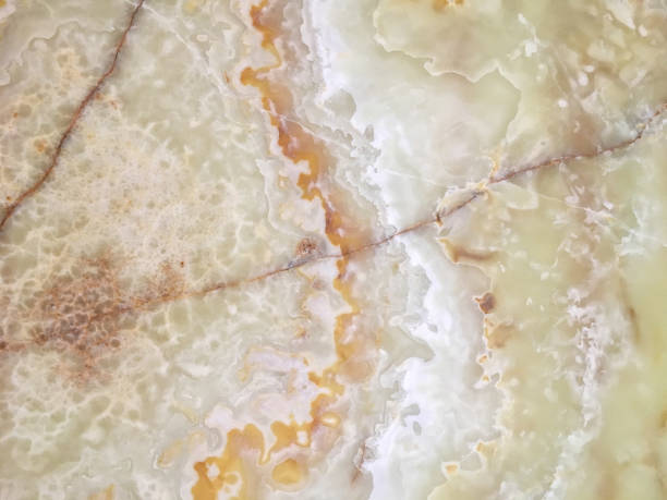 istock Beige marble in a cut close-up with white impregnations. 1002873264