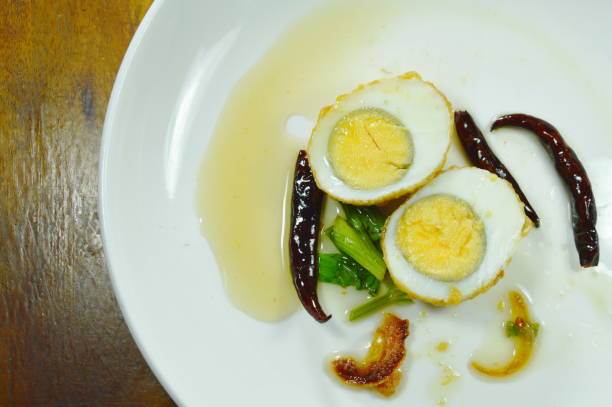 istock fried egg half cut dressing sweet tamarind sauce topping chili 1002873442