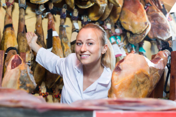 istock Laughing female selling prosciutto meat 1002874490