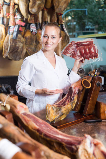 istock Positive young woman holding iberian ham 1002874492