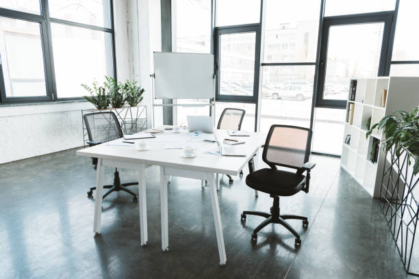 istock modern office interior with desk, papers, chairs and whiteboard 1002875622