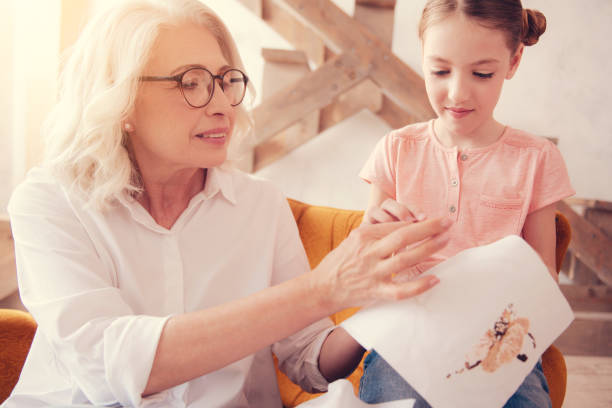 istock Mindful senior woman teaching grandchild embroidering 1002877148