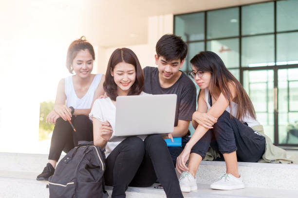 istock education, school and people concept - Cheerful university students with notebook; Asia university. 1002877384