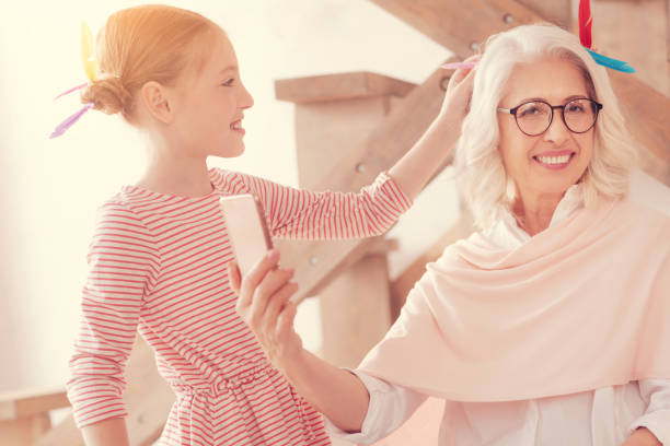 istock Joyful retired lady taking selfies with new hairstyle 1002878632