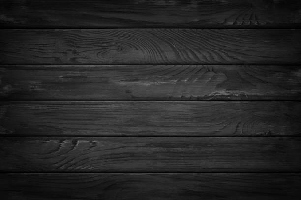 istock dark wood. Rustic wooden table background top view 1002879844