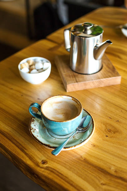 istock Coffeebrak at the restaurant. Blue mug, Cappuccino 1002884254