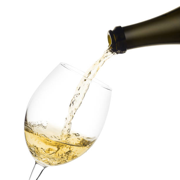 istock white wine poured from a bottle into wine glass on white backgro 1002884642